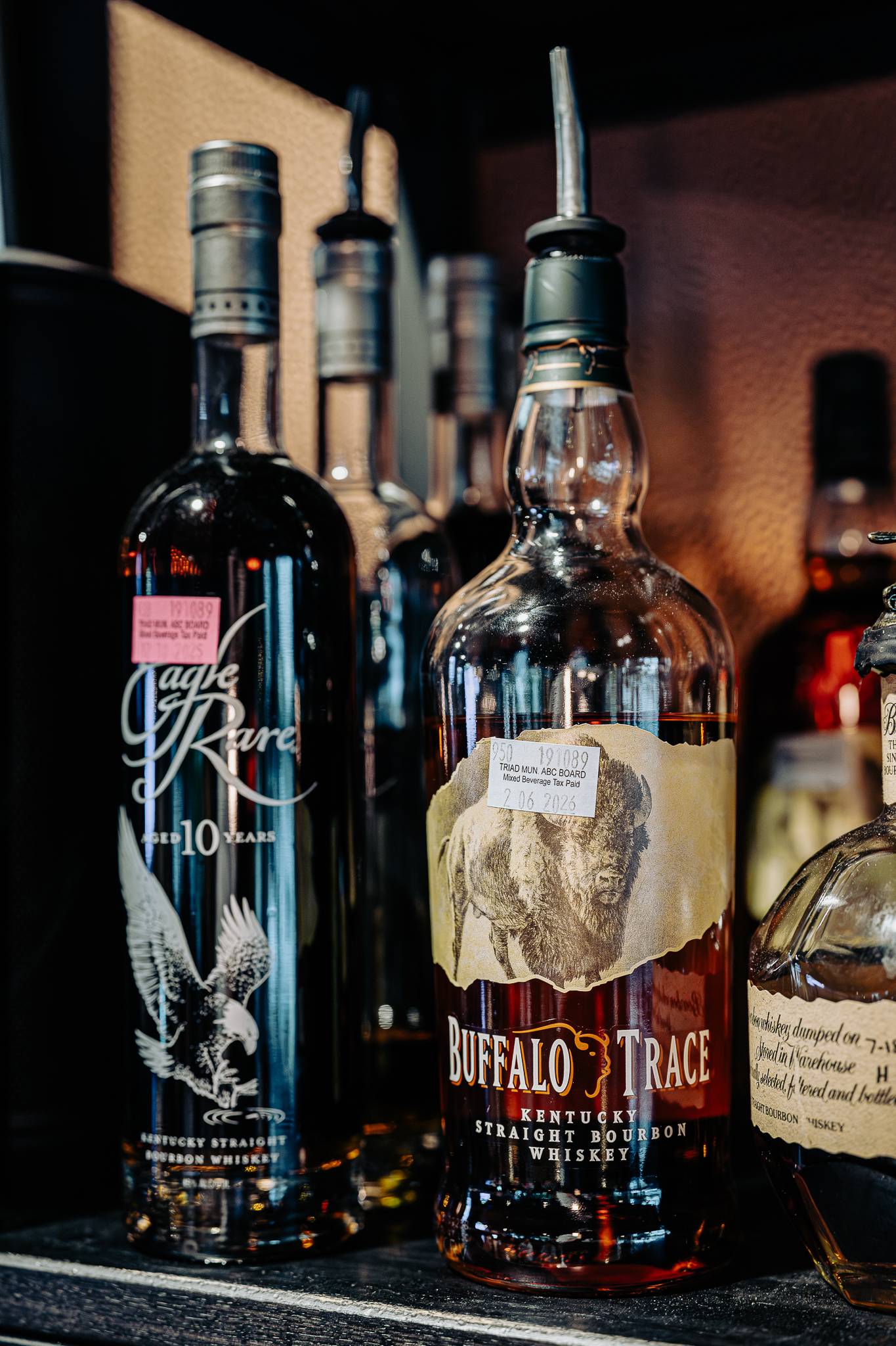 Eagle Rare and Buffalo Trace bourbon bottles on the shelf