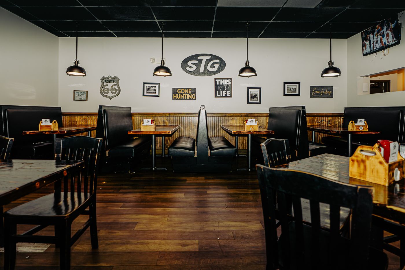 StokeRidge dining room with booths, STG sign, and warm wood interior