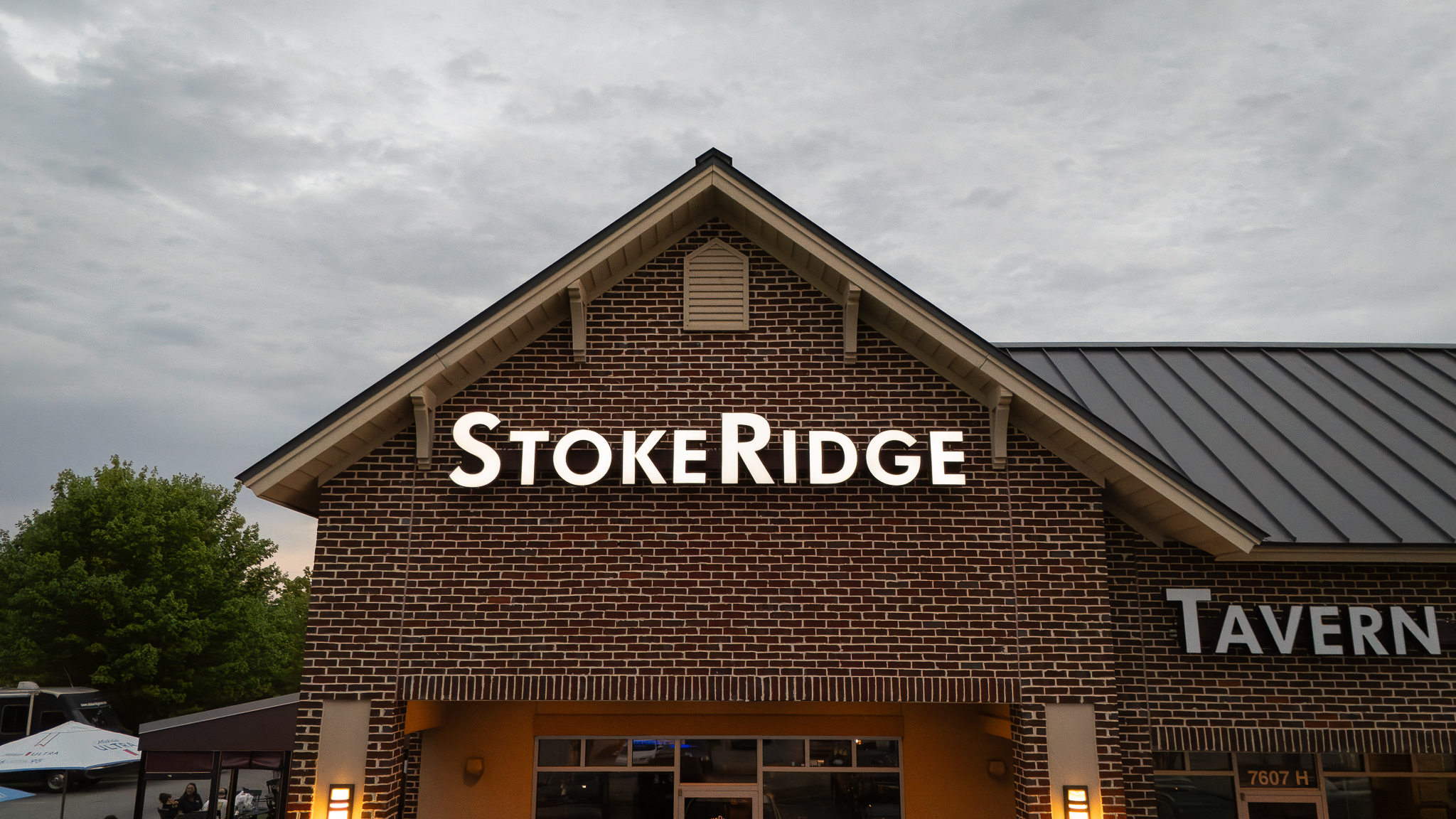 StokeRidge exterior at dusk, full building with sign lit up